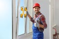 Worker using suction lifters during plastic window installation indoors Royalty Free Stock Photo