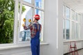 Worker using suction lifters during plastic window installation indoors Royalty Free Stock Photo