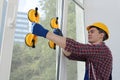 Worker using suction lifters during plastic window installation indoors Royalty Free Stock Photo