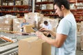 Worker Using Tablet Computer In Distribution Warehouse Royalty Free Stock Photo