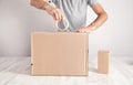 Worker using tape sealing cardboard box. Products, Commerce, Retail, Delivery Royalty Free Stock Photo