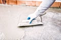 Worker using trowel and mason's float for hydroisolating and waterproofing house Royalty Free Stock Photo