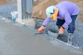 worker using trowel plasters wet concrete cement floor Royalty Free Stock Photo