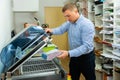 Worker using vacuum packing machine in printing shop Royalty Free Stock Photo