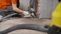 Worker vacuuming dust at a construction site. Vacuum cleaner for cleaning large. High power Machine for industry, floor buffing