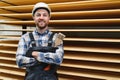 A worker varnishes boards for the construction of a wooden house. Royalty Free Stock Photo