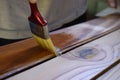 Worker varnishes wood Royalty Free Stock Photo