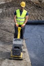 Worker with vibrating plate compactor Royalty Free Stock Photo