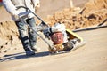 Worker with vibration compactor Royalty Free Stock Photo