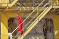 Worker walking down the stairs in plant