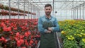 Worker walking in a flowerpot. Agricultural engineer working in greenhouse. Royalty Free Stock Photo