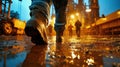 Worker walking in rainy construction site with reflective lights and muddy ground Royalty Free Stock Photo