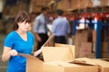 Worker In Warehouse Checking Boxes Using Digital Tablet Royalty Free Stock Photo