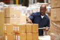 Worker In Warehouse Preparing Goods For Dispatch Royalty Free Stock Photo