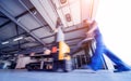 A worker in a warehouse uses a hand pallet stacker to transport pallets. Royalty Free Stock Photo