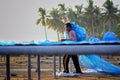 A worker was busy drying the fish for the process of drying the fish under the sun's heat before it became salted fish.