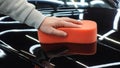 A worker washes a black car Royalty Free Stock Photo