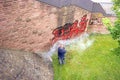 A worker washes a wall