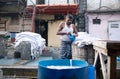 Worker washing clothes at Dhobi Ghat in Mumbai, India Royalty Free Stock Photo