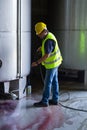 Worker washing industrial site Royalty Free Stock Photo