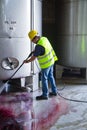 Worker washing industrial site Royalty Free Stock Photo