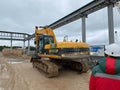 Worker watching digger moving waste at landfill site Royalty Free Stock Photo