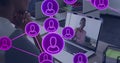 Worker watching laptop at desk with headset purple network overlay, leaning on hands, copy space Royalty Free Stock Photo