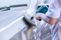 Worker waxing a car with auto polisher Royalty Free Stock Photo
