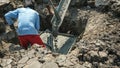 Worker wear blue shirt use cement from truck filling foundation piles cavity