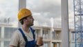 Worker wearing hardhat taking a break drinking coffee. Royalty Free Stock Photo