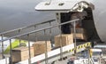 A worker wearing a protective gear unloads personal protection equipment from a plane