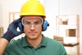 Worker wearing safety headphones indoors. Hearing protection device Royalty Free Stock Photo