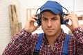 Worker wearing safety headphones indoors. Hearing protection device Royalty Free Stock Photo