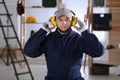 Worker wearing safety headphones indoors. Hearing protection device Royalty Free Stock Photo