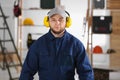 Worker wearing safety headphones indoors. Hearing protection device Royalty Free Stock Photo