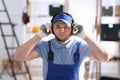 Worker wearing safety headphones indoors. Hearing protection device Royalty Free Stock Photo