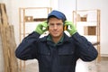 Worker wearing safety headphones indoors. Hearing protection device Royalty Free Stock Photo