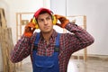 Worker wearing safety headphones indoors. Hearing protection device Royalty Free Stock Photo