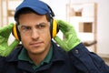 Worker wearing safety headphones indoors. Hearing protection device Royalty Free Stock Photo