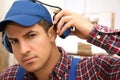 Worker wearing safety headphones indoors. Hearing protection device Royalty Free Stock Photo