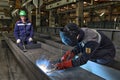 Worker welder manually weld steel sheets using gas torch, MIG.