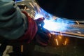 Worker welder performs production operations at the factory