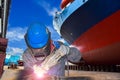 Worker Welding close-up at floating dry dock in shipyard for ship repair