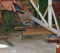 Worker with a welding machine fixing a caster wheels, fiery sparks flying around