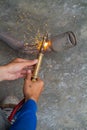 Worker welding metal exhaust pipe with sparks