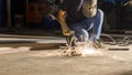 worker welding metal, focus on flash light line of sharp spark,in low light Royalty Free Stock Photo