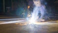 worker welding metal, focus on flash light line of sharp spark,in low light Royalty Free Stock Photo