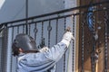 A worker welding metal handrails on the stairs. Ukraine.