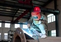 Worker welding a metal lattice at
