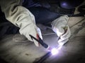 Worker welding stainless tank using tig welder